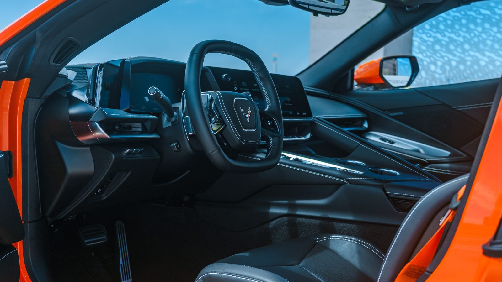 Interior cockpit of an orange Corvette C8 Stingray rental in Las Vegas